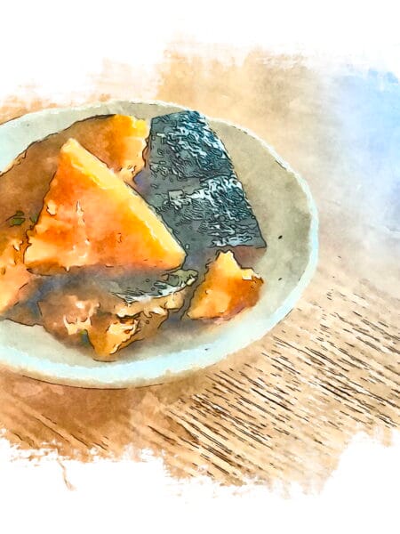 Watercolor-style illustration of braised kabocha squash pieces arranged on a cream-colored ceramic plate. The golden-orange squash segments show caramelized edges from braising, alongside what appears to be kombu seaweed. The artistic rendering emphasizes the natural colors and textures of this traditional shōjin ryōri preparation.