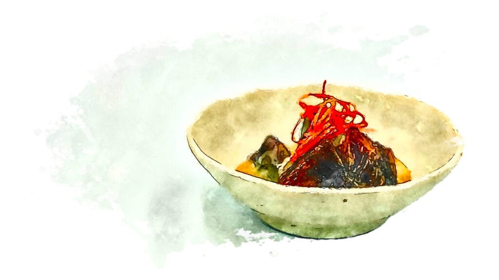 Fuyu persimmon with sesame cream and a garnish of its own skin in an off-white bowl.
