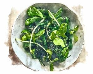 Green beans tossed with black sesame dressing (goma-ae) served in an off-white bowl.