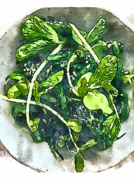 Green beans tossed with black sesame dressing (goma-ae) served in an off-white bowl.