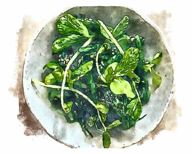 Green beans tossed with black sesame dressing (goma-ae) served in an off-white bowl.