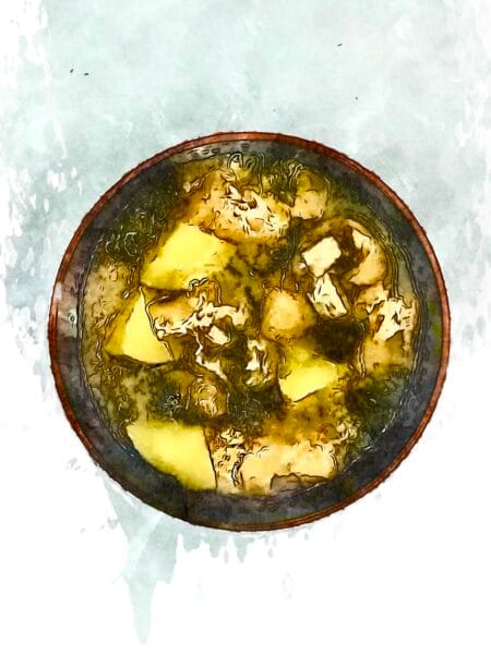 A wooden bowl filled with piping hot potato and seaweed miso soup.
