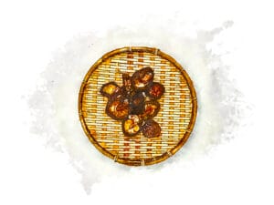 Overhead view of dried shiitake mushrooms arranged on a round bamboo drying basket.