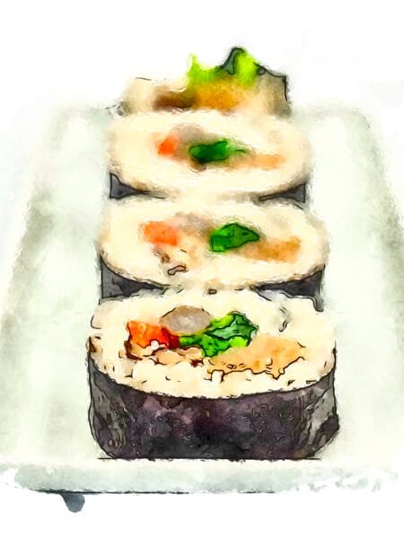 Four slices of colorful vegetable futomaki (thick roll) arranged in a row.