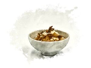 A white ceramic bowl filled with warm maitake mushroom rice.