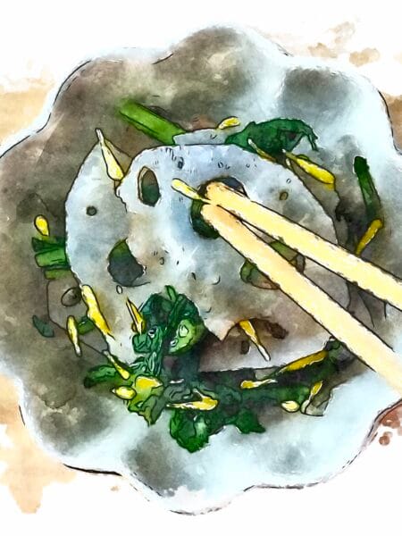Lotus root and chrysanthemum greens salad being garnished with bright yellow flower petals.